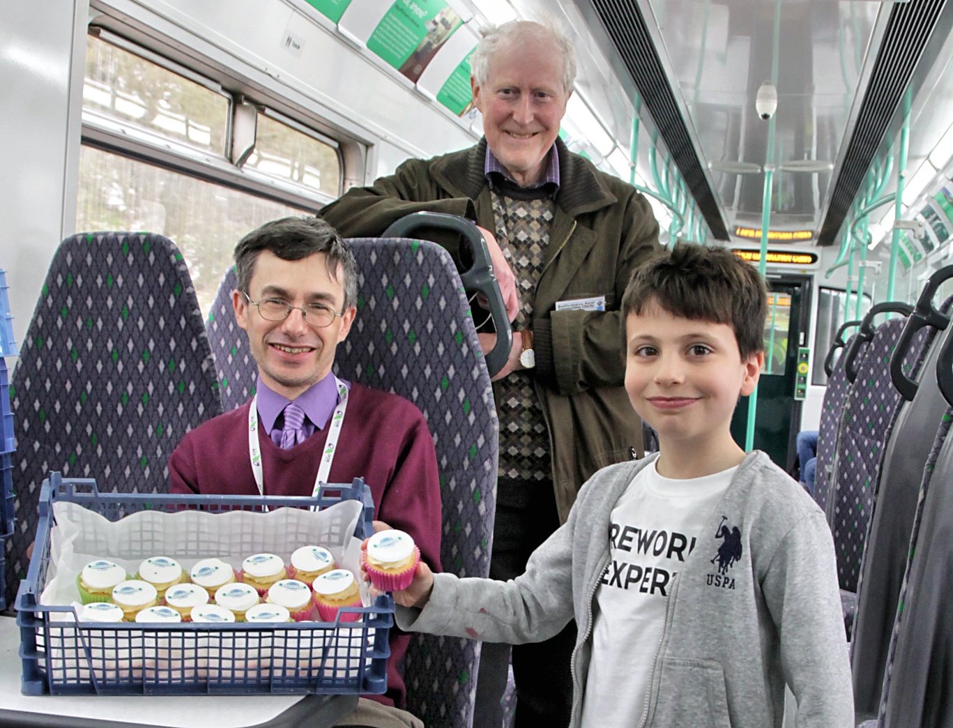Cupcakes being distributed on a train.
